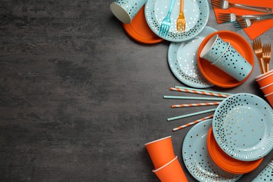 Photo of Flat lay composition with disposable tableware on dark grey background, space for text