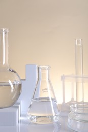 Photo of Laboratory analysis. Different glassware on table against beige background