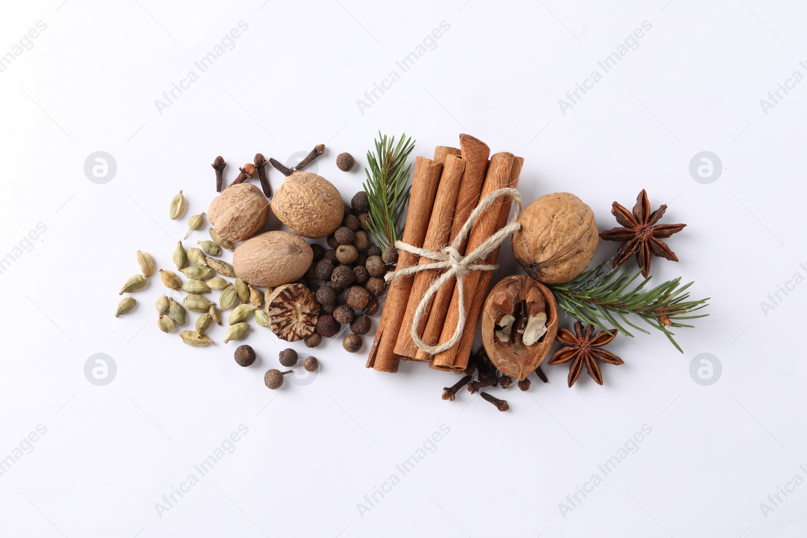 Photo of Different spices and fir branches on white table, flat lay