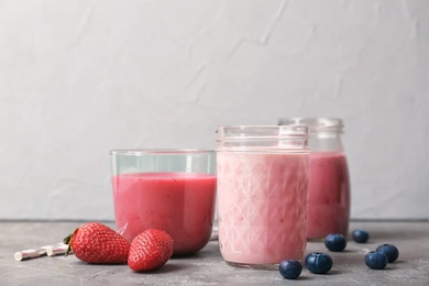 Glassware with healthy detox smoothies and ingredients on table