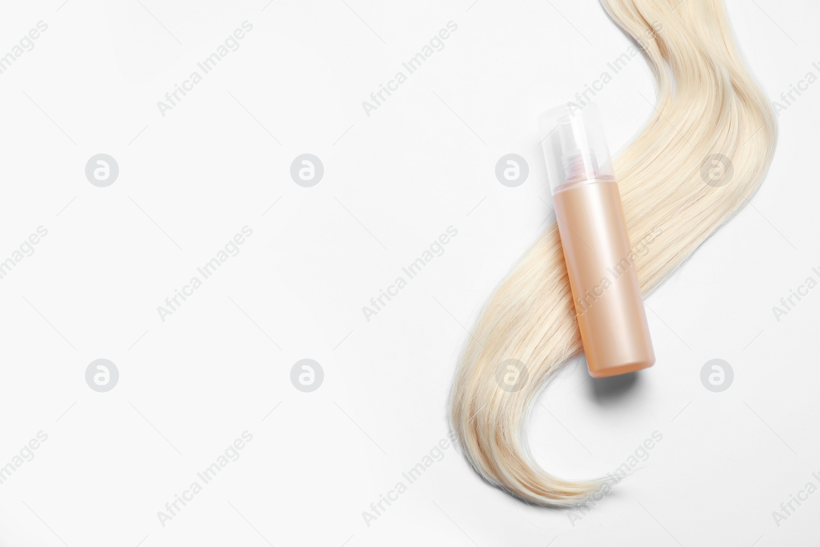 Photo of Spray bottle with thermal protection and lock of blonde hair on white background, flat lay. Space for text