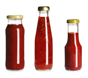 Image of Set with delicious sauces in glass bottles on white background