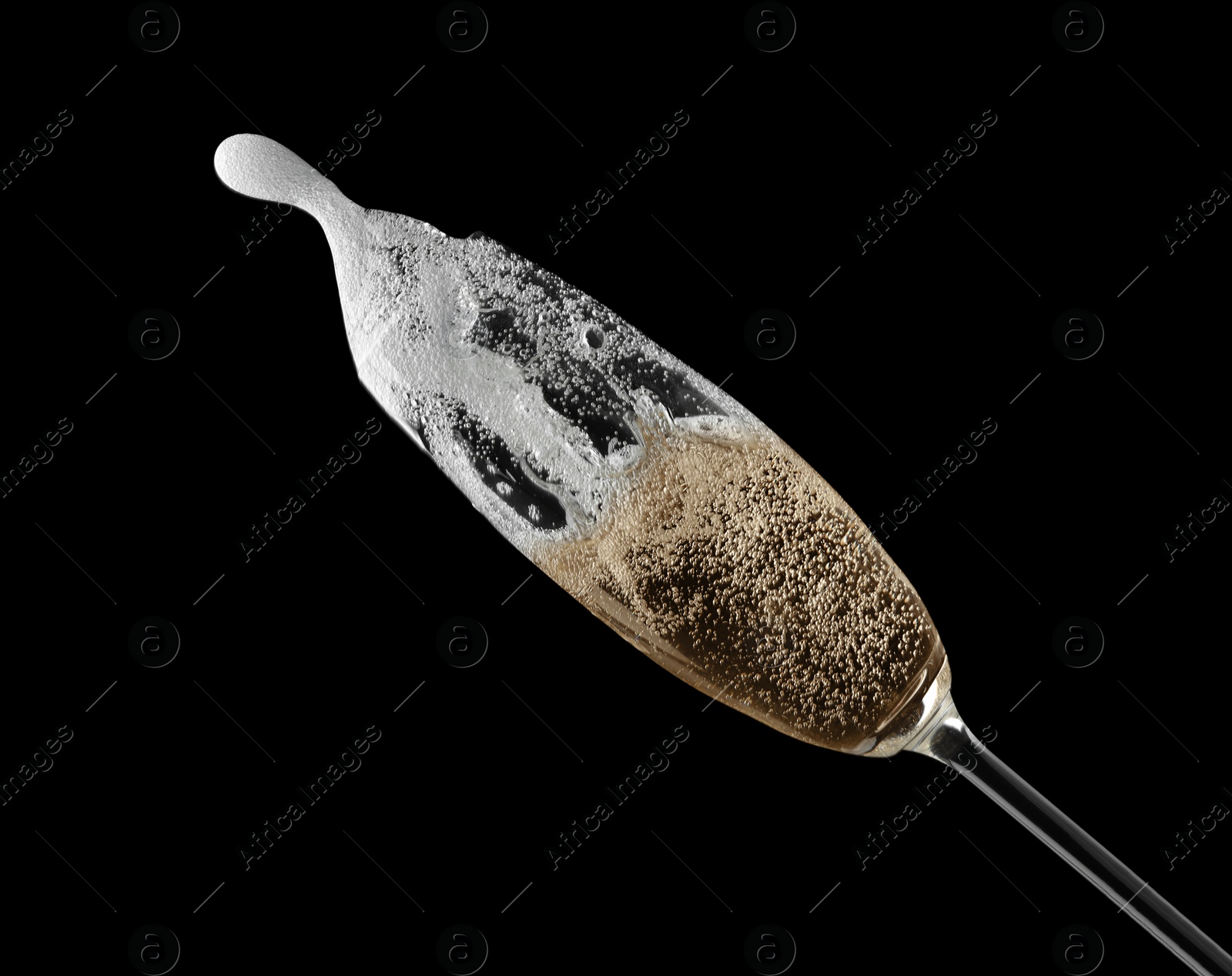 Photo of Glass of fizzy champagne on black background, closeup