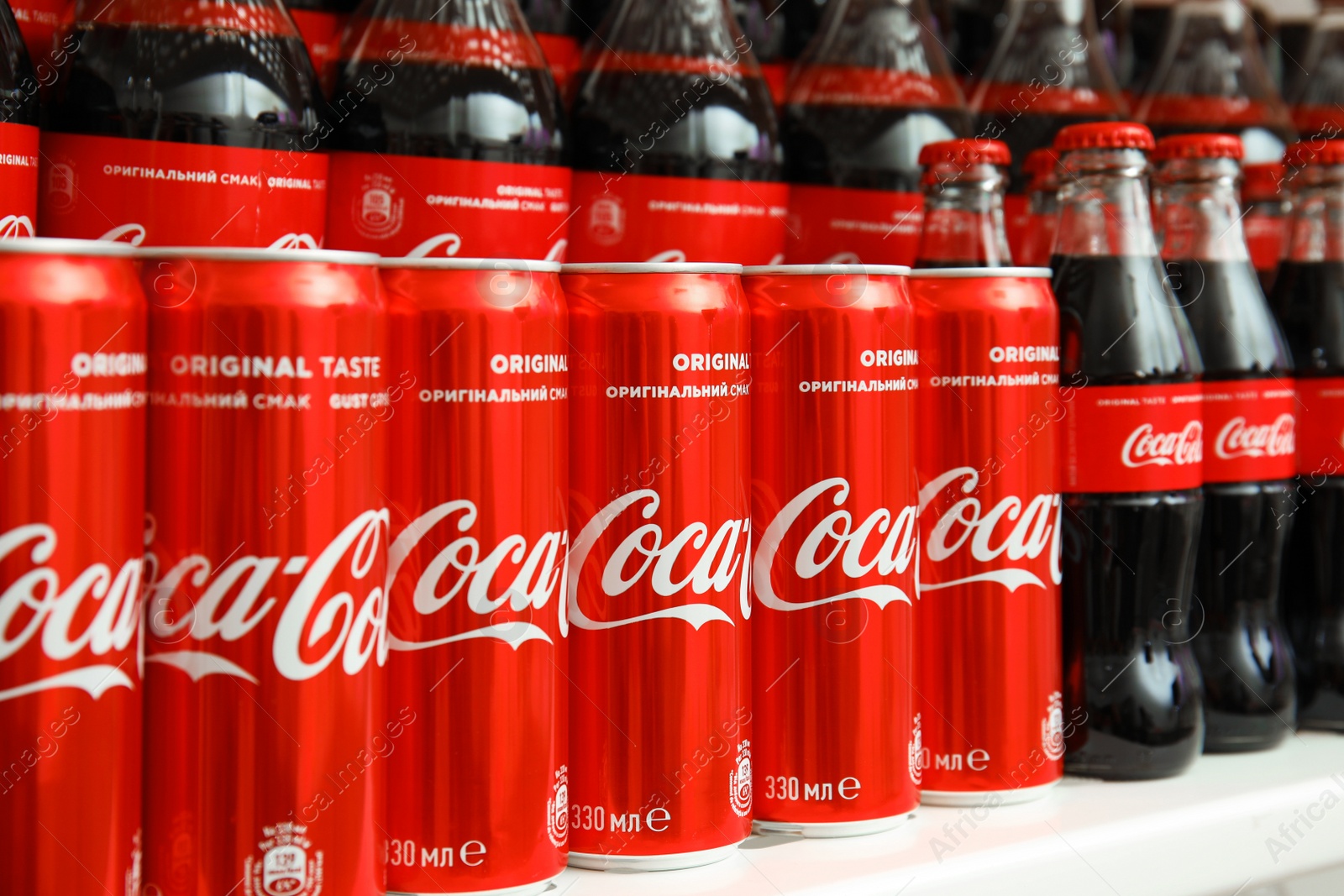 Photo of MYKOLAIV, UKRAINE - NOVEMBER 14, 2018: Coca-Cola cans and bottles on display in store