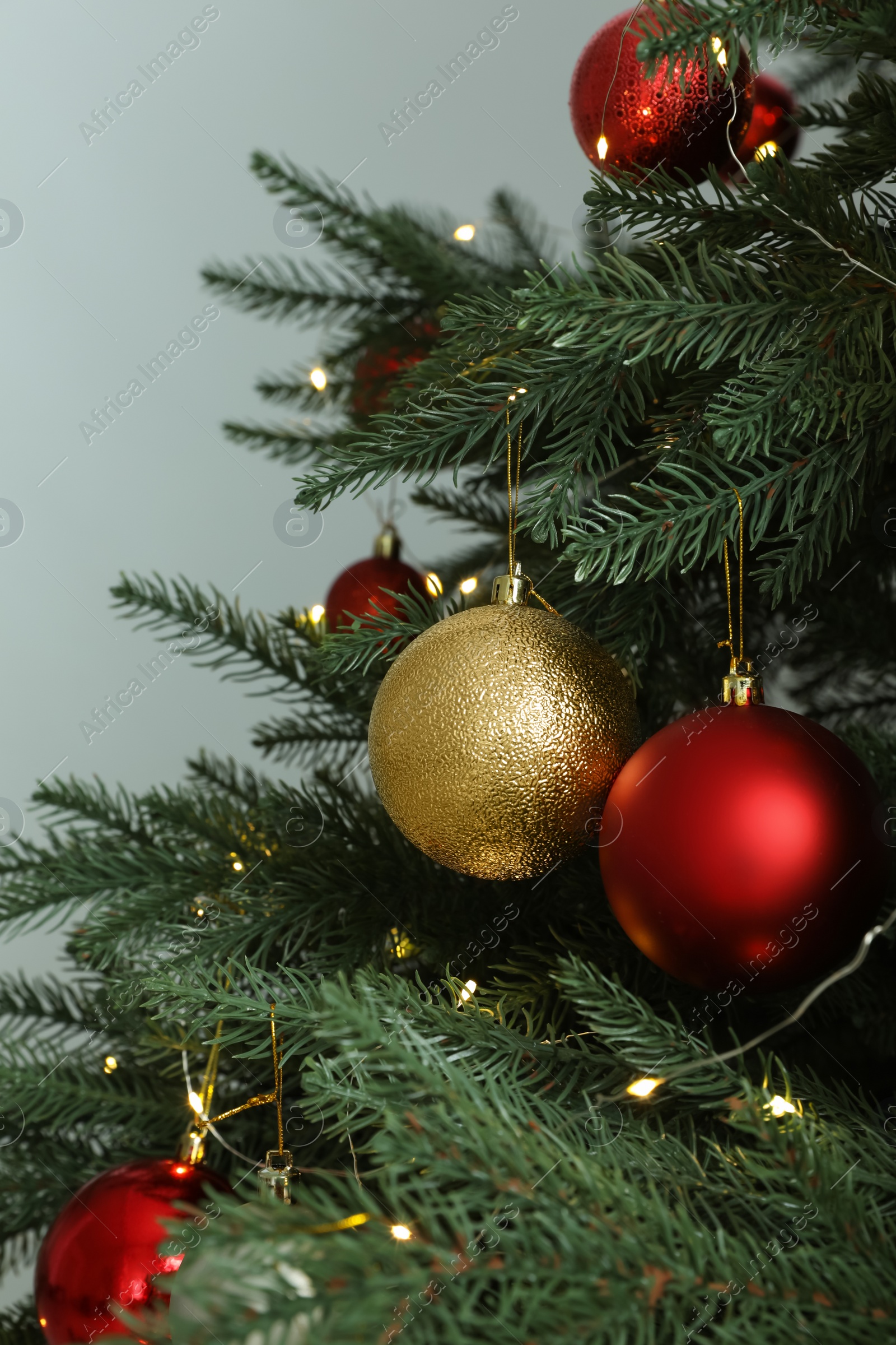 Photo of Beautiful Christmas tree with shiny baubles on white background, closeup