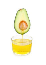 Photo of Essential oil dripping from cut avocado into bowl on white background