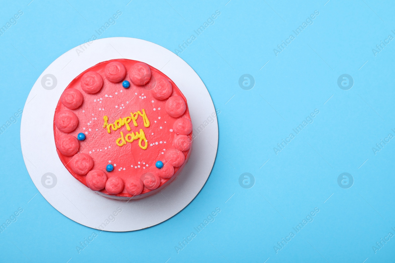 Photo of Cute bento cake with tasty cream on light blue background, top view. Space for text