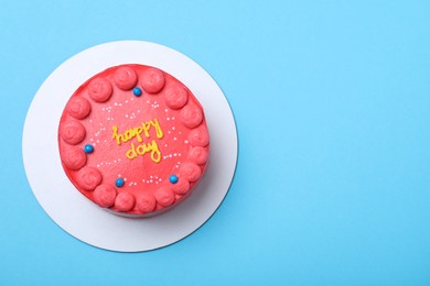Cute bento cake with tasty cream on light blue background, top view. Space for text