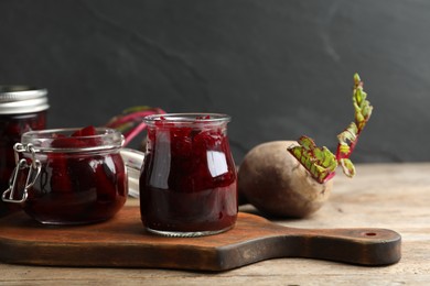 Photo of Delicious pickled beets and spices on wooden table