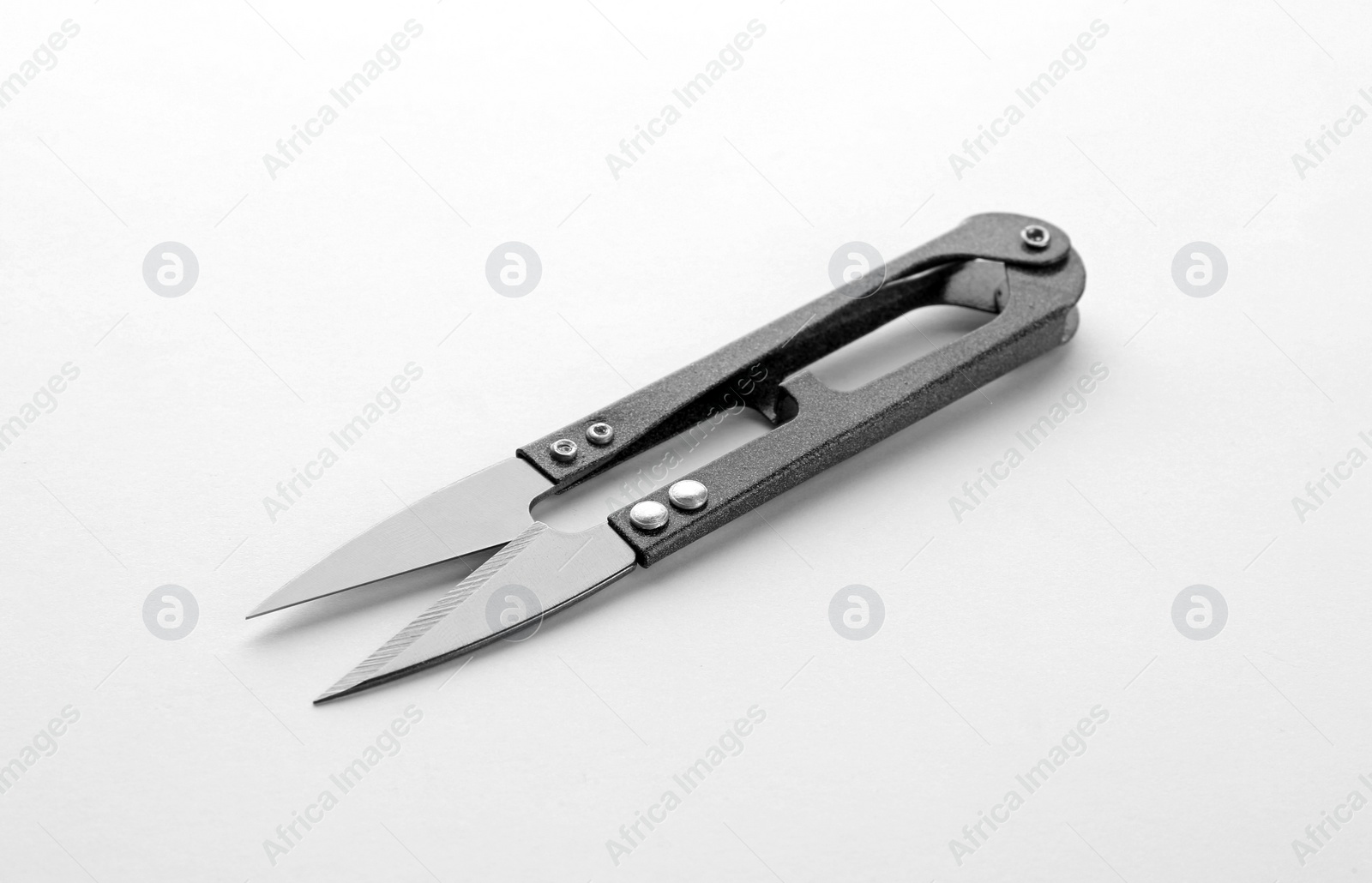 Photo of Pair of sewing scissors on white background