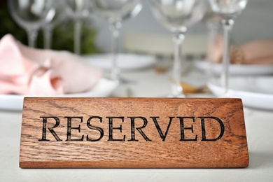 Table setting with RESERVED sign in restaurant