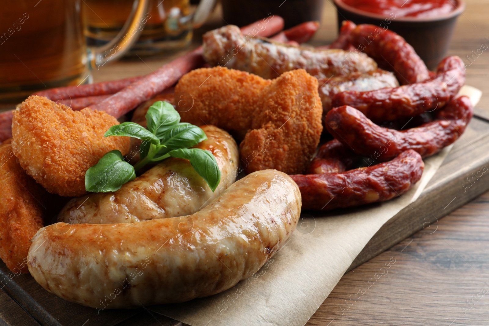 Photo of Set of different tasty snacks on wooden table, closeup view