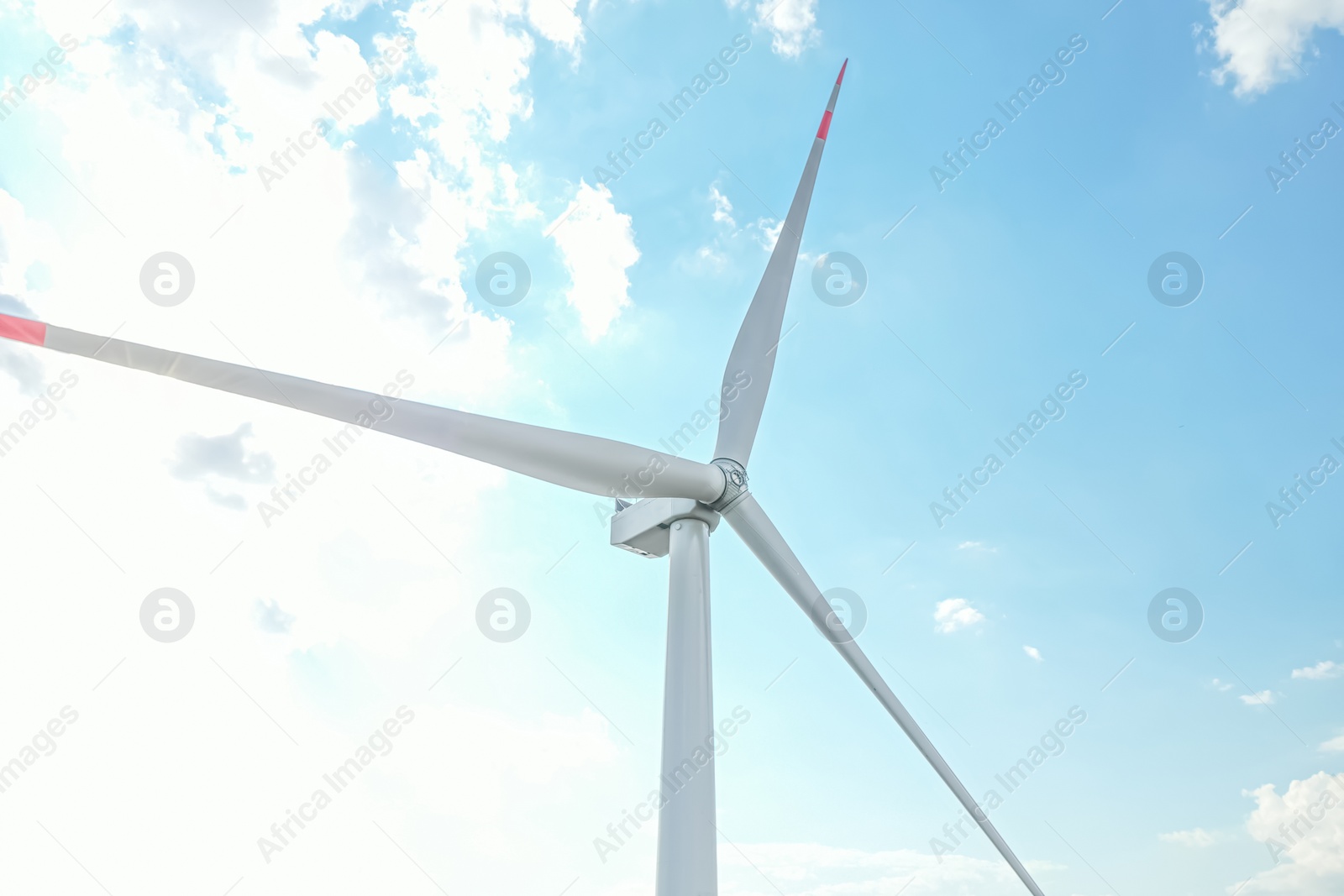 Photo of Modern windmill against sky with clouds. Energy efficiency