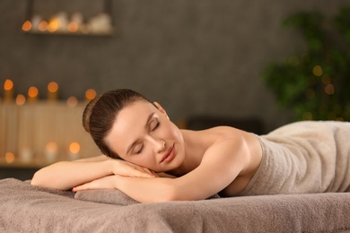 Photo of Beautiful young woman relaxing in spa salon