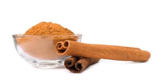 Photo of Dry aromatic cinnamon sticks and powder isolated on white