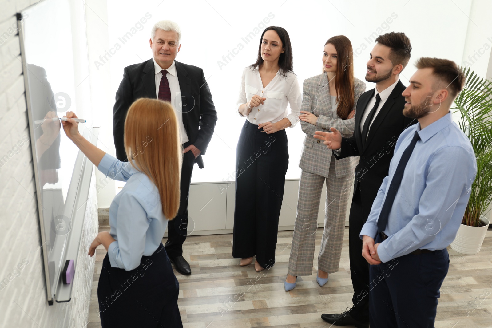 Photo of Professional business trainer working with people in office