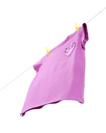 One violet t-shirt drying on washing line isolated on white