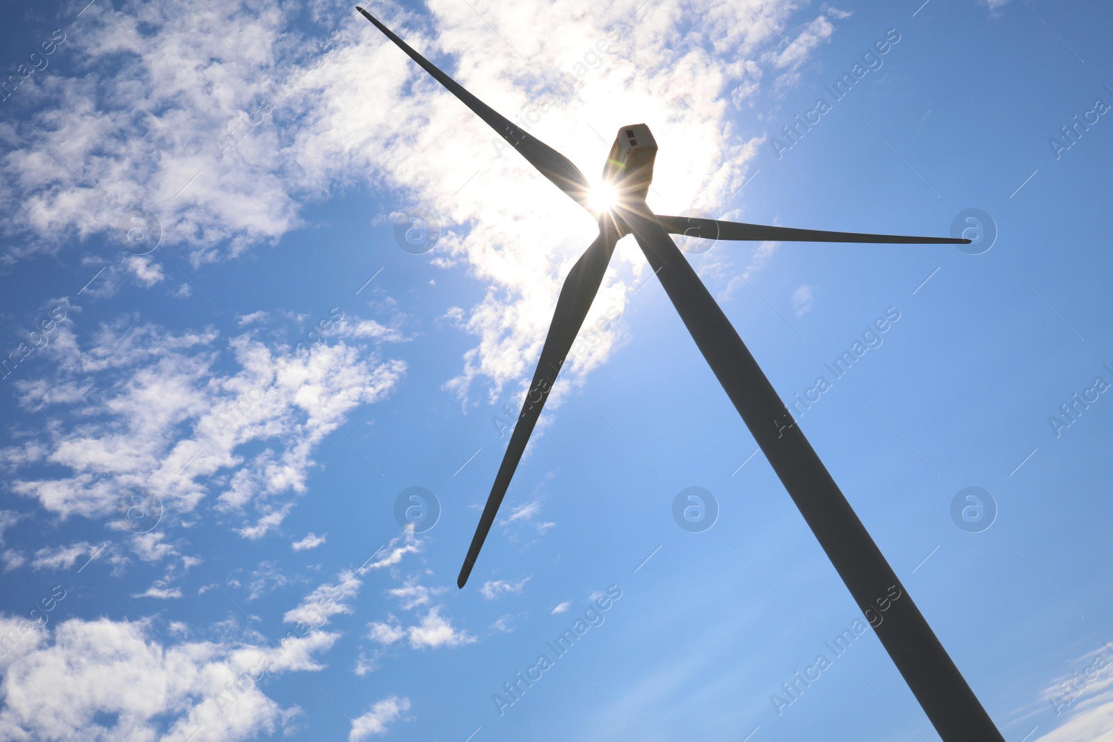 Photo of Wind turbine against beautiful blue sky, low angle view. Alternative energy source