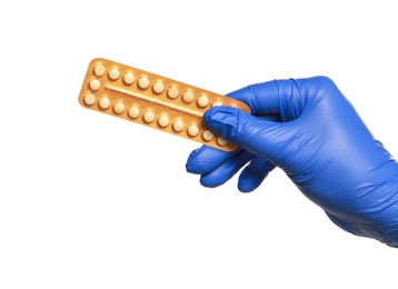 Doctor holding blister of oral contraception pills on white background, closeup