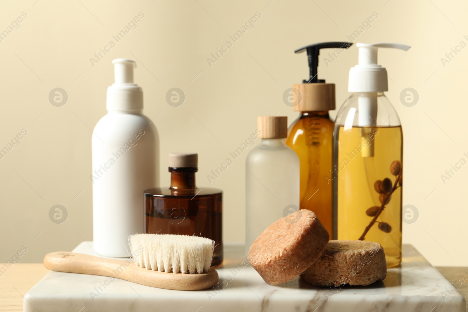 Photo of Different bath accessories on table against beige background, closeup