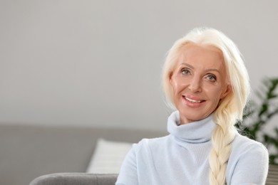 Photo of Portrait of happy mature woman at home. Space for text