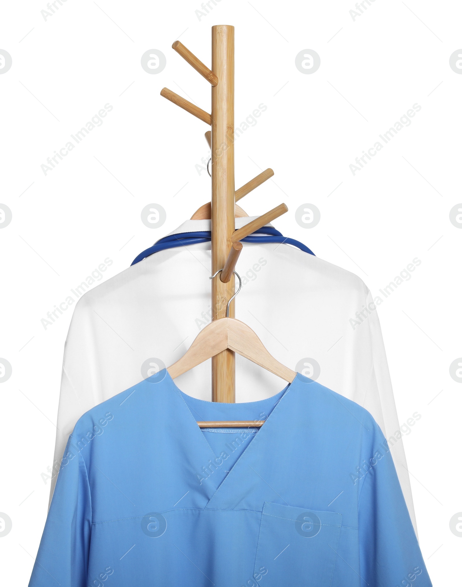 Photo of Light blue medical uniform and doctor's gown on rack against white background