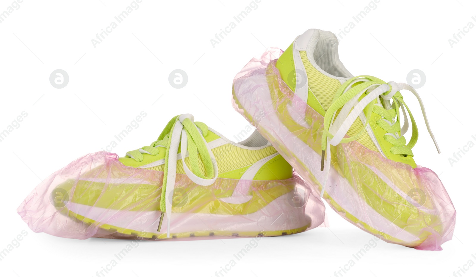 Photo of Sneakers in pink shoe covers isolated on white