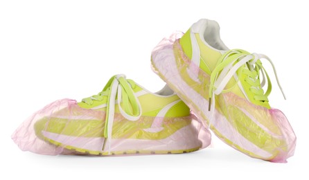 Photo of Sneakers in pink shoe covers isolated on white