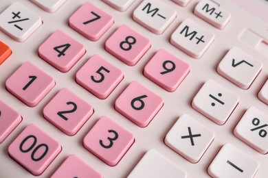 Photo of Closeup view of pink calculator as background