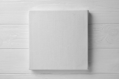 Blank canvas on white wooden background, space for text