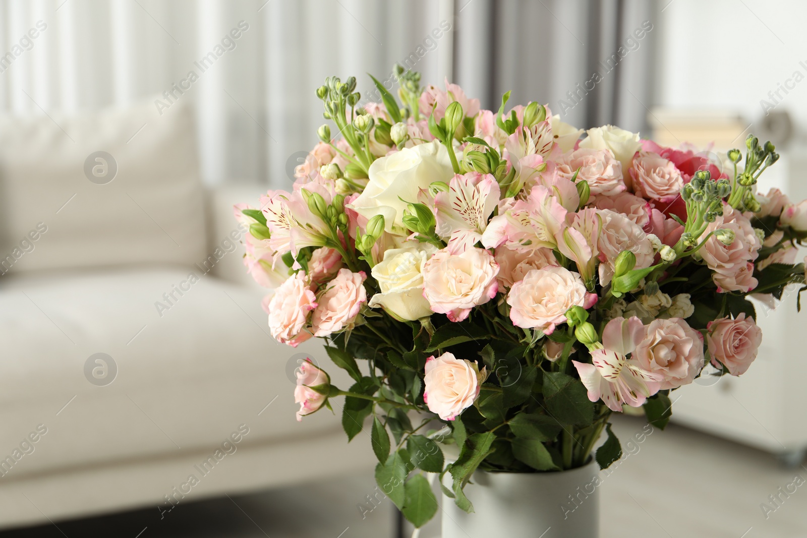 Photo of Beautiful bouquet of fresh flowers in vase indoors, space for text