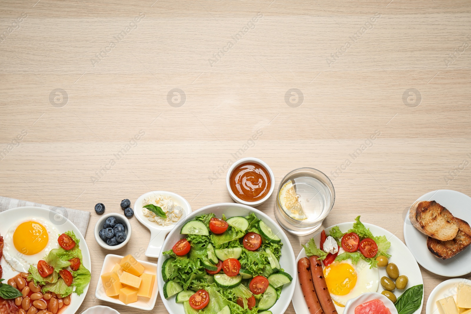 Photo of Different delicious dishes on buffet table, flat lay. Space for text