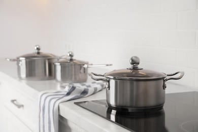 Photo of New clean pot on cooktop in kitchen, space for text