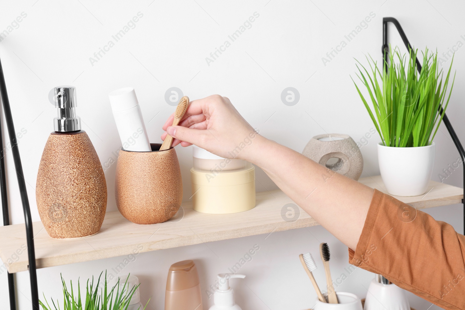 Photo of Bath accessories. Woman organizing personal care products indoors, closeup