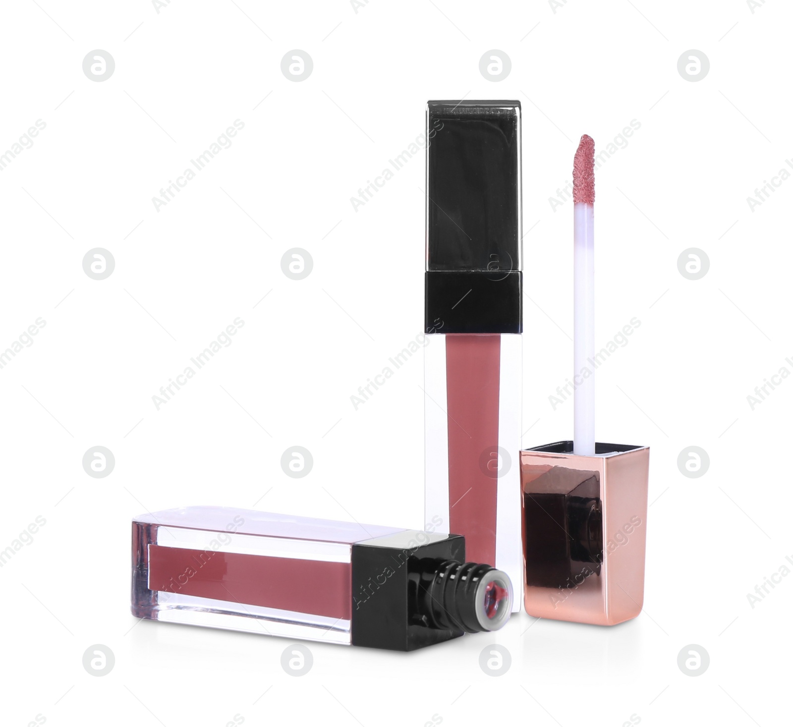 Photo of Lip glosses and applicator isolated on white. Cosmetic products