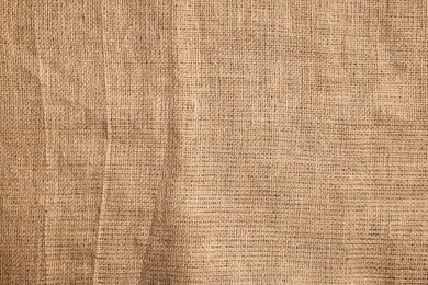 Texture of natural burlap fabric as background, top view