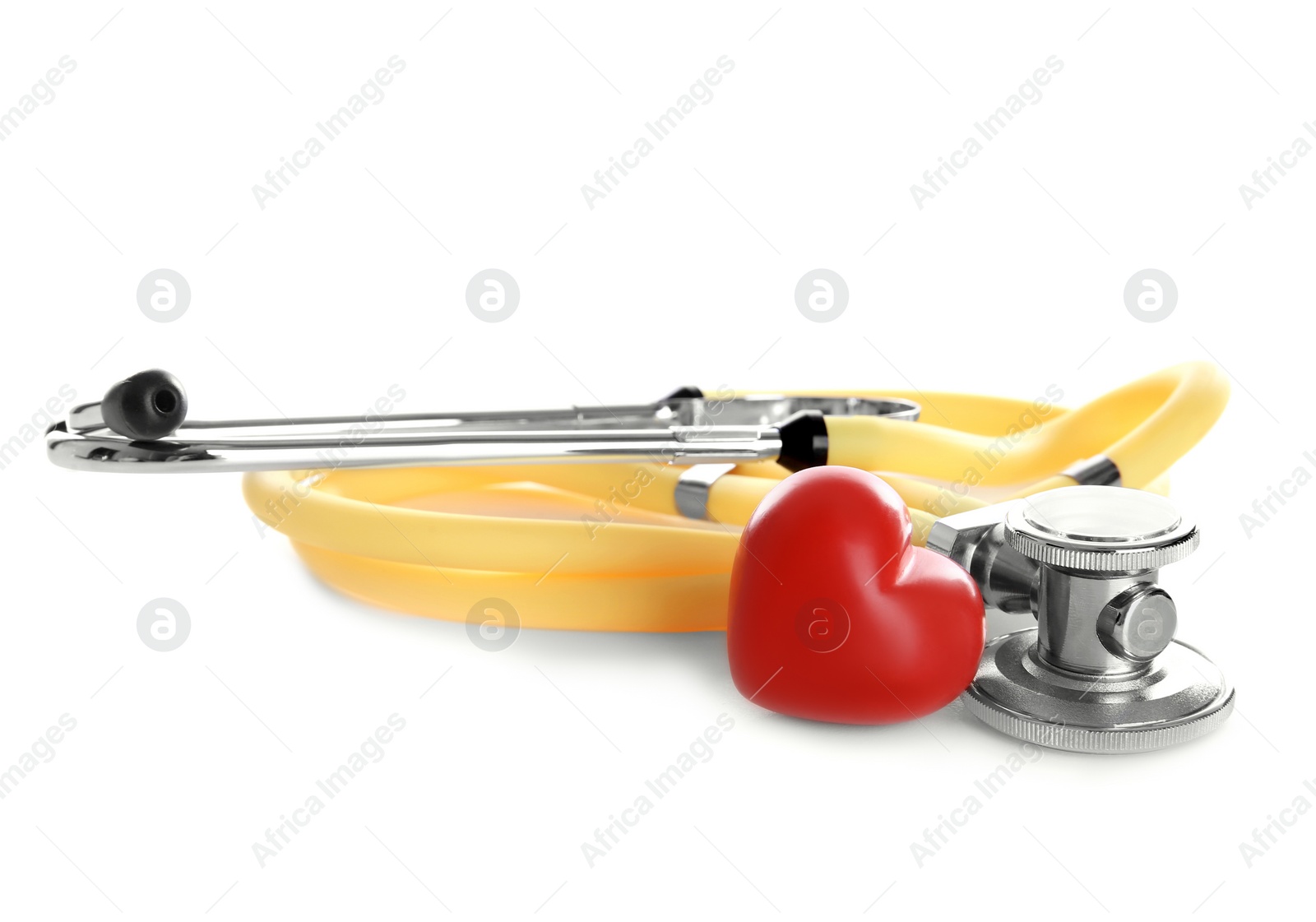 Photo of Stethoscope and small red heart on white background. Heart attack concept