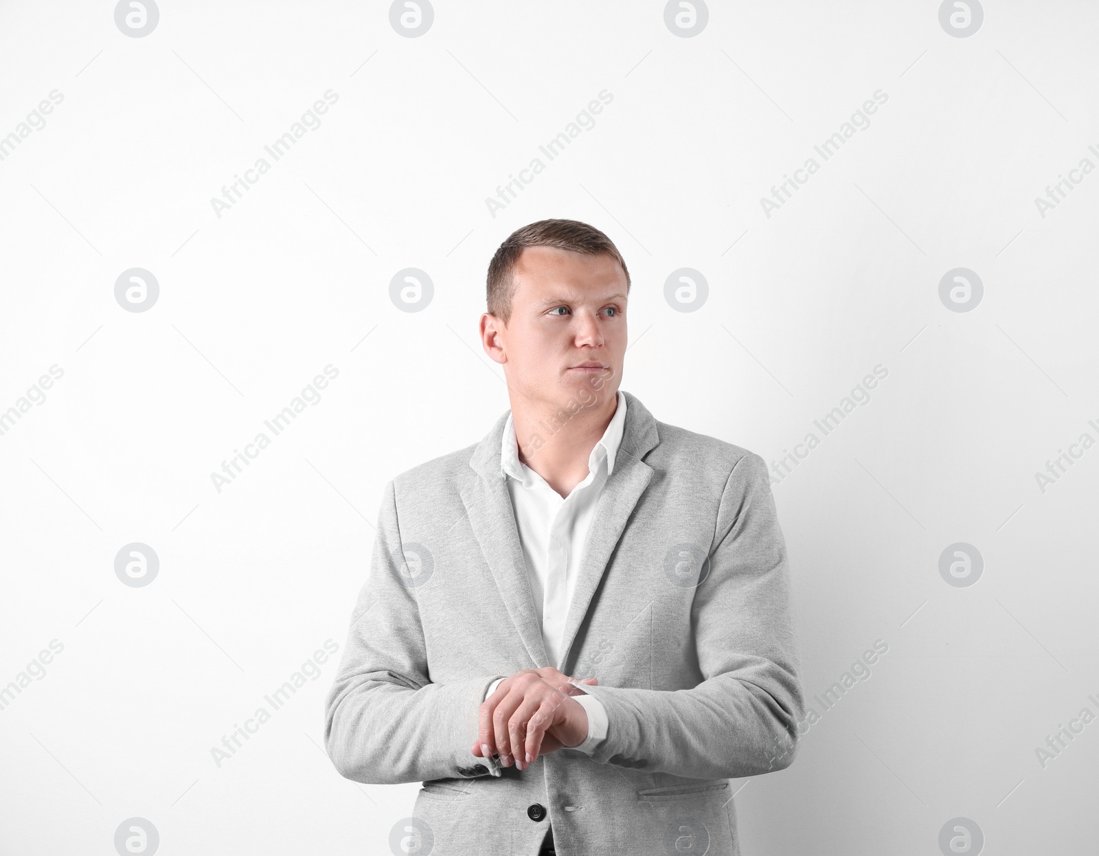 Photo of Handsome young man in suit on white background