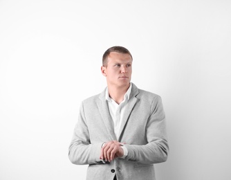 Handsome young man in suit on white background