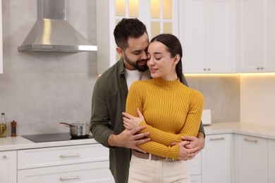 Lovely couple enjoying time together in kitchen