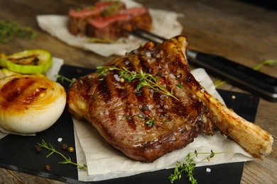 Photo of Tasty grilled meat steak on wooden table