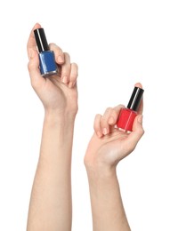 Photo of Woman holding nail polishes on white background, closeup
