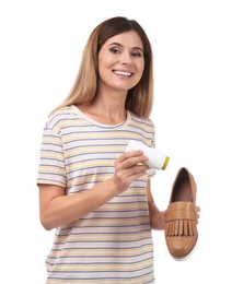 Photo of Woman putting powder freshener into shoe on white background