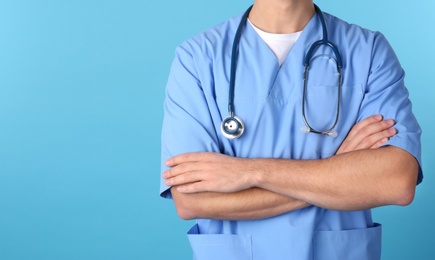 Young medical student in uniform on color background, closeup. Space for text