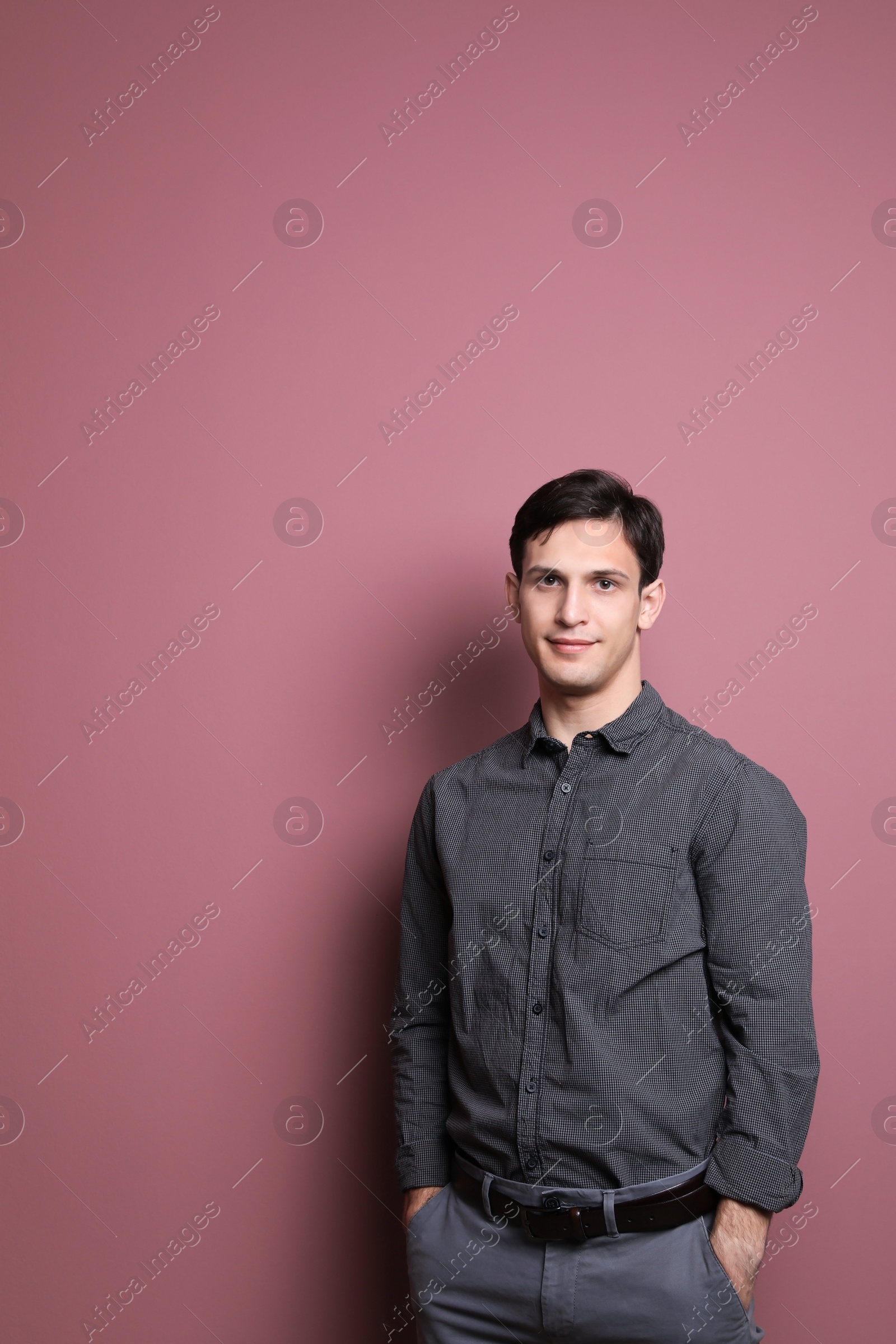 Photo of Portrait of confident young man on color background