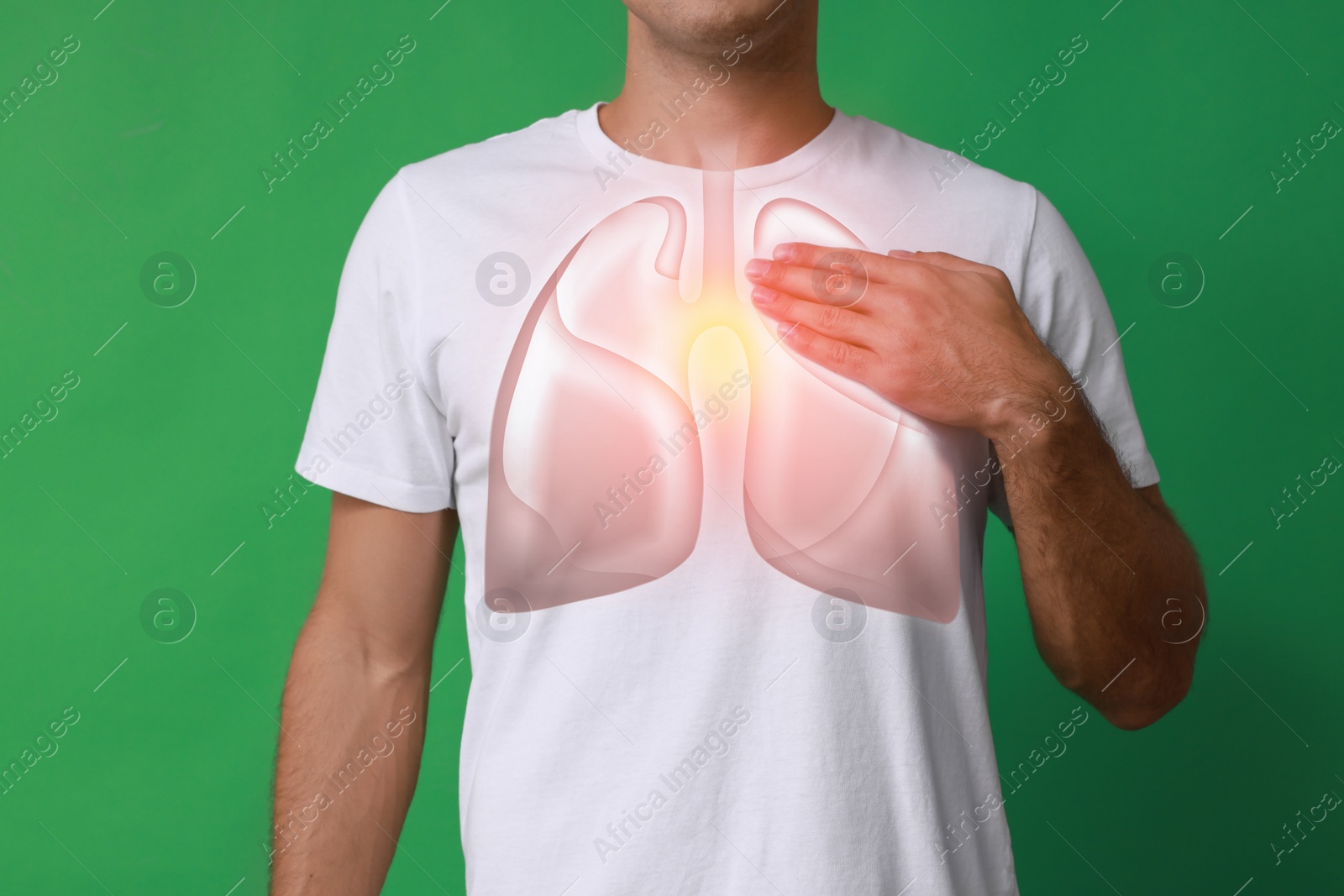 Image of Man holding hand near chest with illustration of lungs on green background, closeup