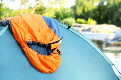 Photo of Sleeping bag on camping tent near lake