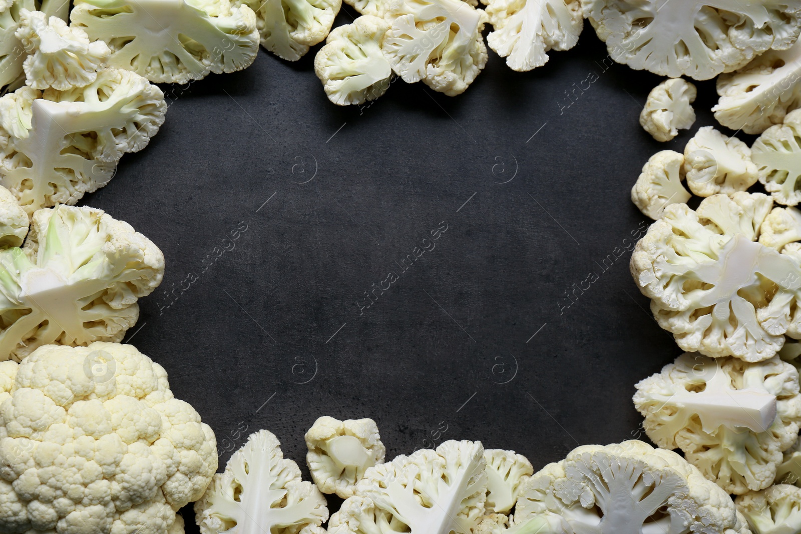 Photo of Frame made of cut fresh raw cauliflower on grey table, flat lay. Space for text