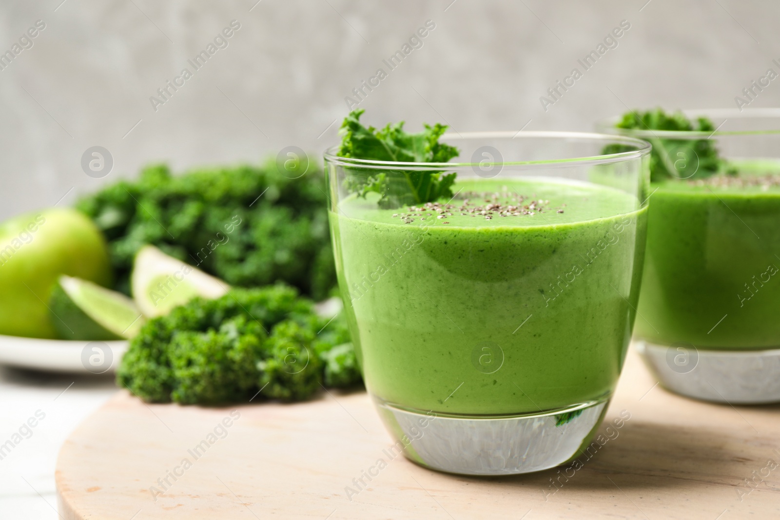 Photo of Tasty kale smoothie with chia seeds on table, closeup