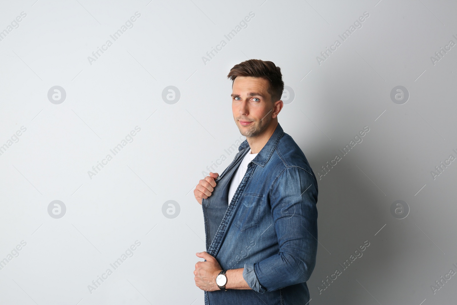 Photo of Portrait of handsome man on light background. Space for text